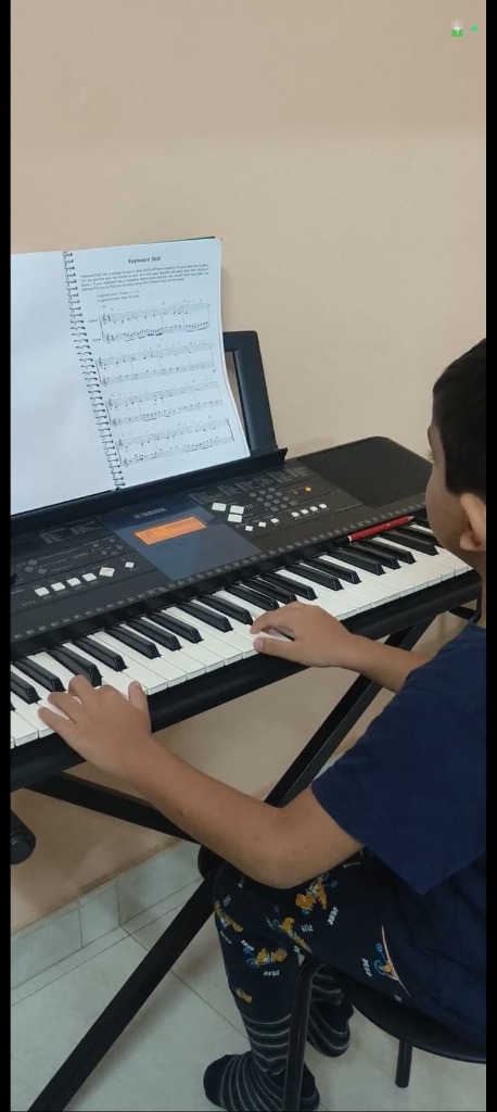 Student playing piano at Swaranthara